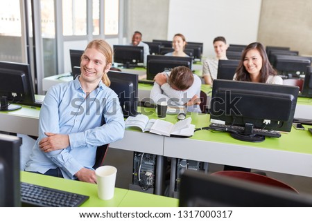 Awake students and sleeping student in computer course in uni