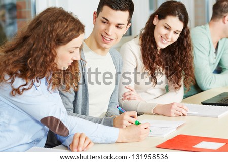 Young woman giving private lessons to school students
