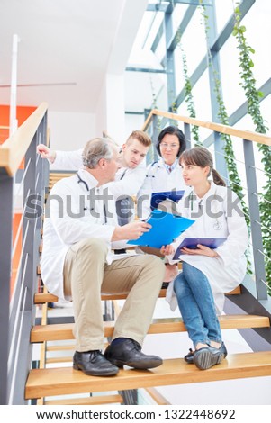 Chief doctor and young physician team discuss therapy treatment