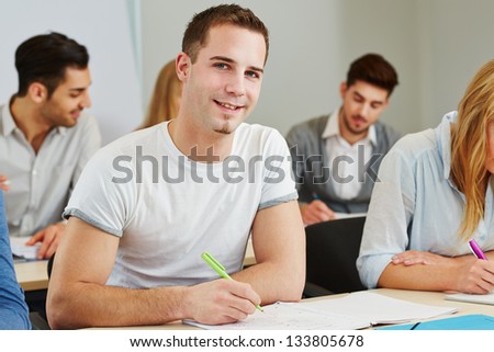Happy student studying in a course of a college