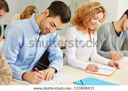 Man and woman taking employee screening in assessment center