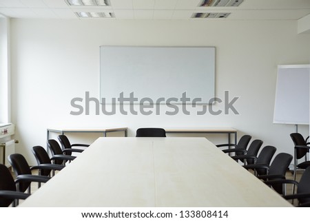 Clean bright white conference room with a whiteboard