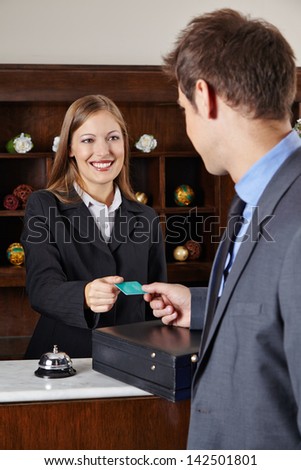 Businessman In Hotel At Reception Getting His Room Key Card
