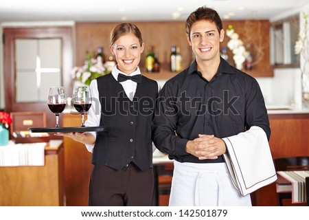 Team Of Waiter Staff With Wine Glasses In A Restaurant