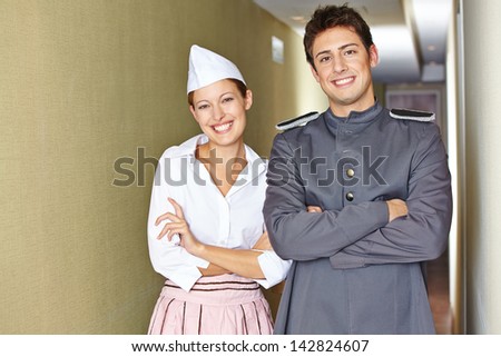 Smiling service staff in hotel with their arms crossed