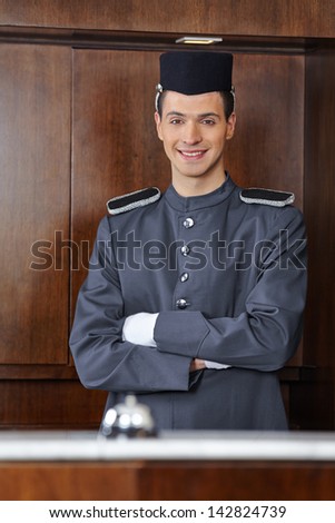 Portrait of a concierge in hotel with his arms crossed