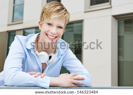 Young business woman with headphones in urban city