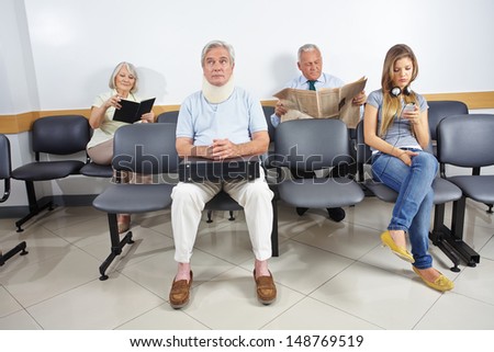 Different People Sitting In A Waiting Room Of A Hospital