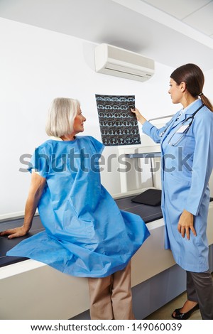 Doctor looking at x-ray images of a senior patient in radiology