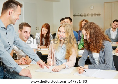 Teacher helping students in university seminar class