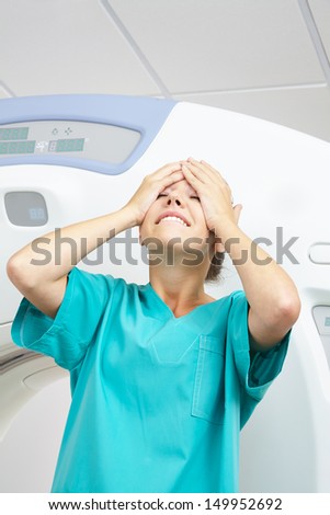 Young MTA slapping happily her face with her hand in a hospital