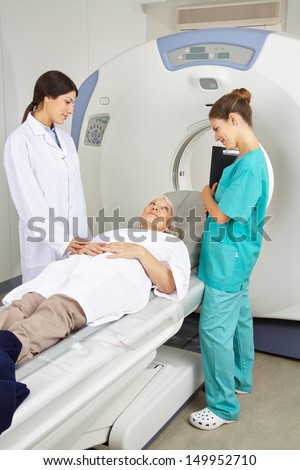 Doctor and nurse talking to patient prior to a magnetic resonance imaging therapy