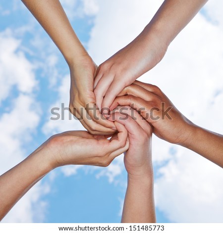 Many hands connecting for help in a spiral under a sky