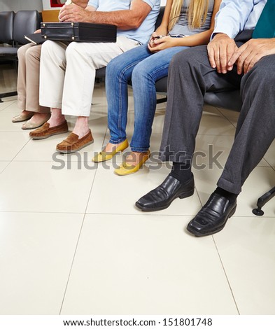 Group Of Patients Sitting In Waiting Room Of A Doctor