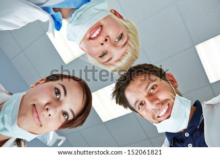 Dentist and dental team looking down during treatment on patient