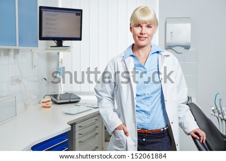 Portrait of happy female dentist in her dental practice
