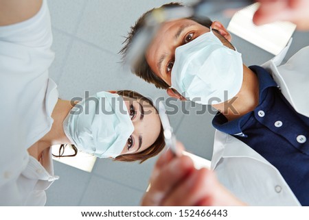 Patient POV of dentist and dental assistant during dental treatment