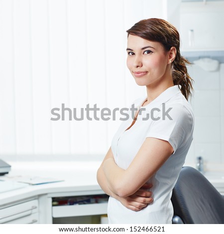 Portrait of an attractive dental assistant with her arms crossed in dental practice