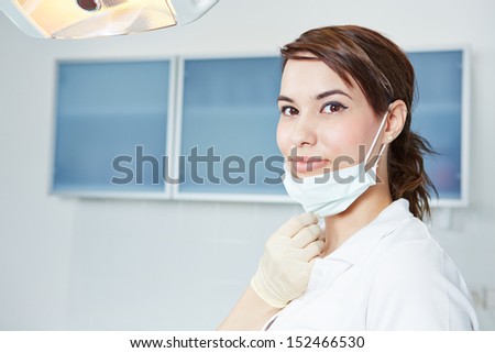 Smiling dental assistant with mouthguard in dental practice