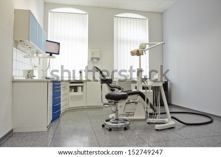 Modern bright treatment room in dental practice with dental chair
