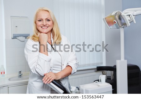 Portrait of a smiling elderly female dentist in her dental practice