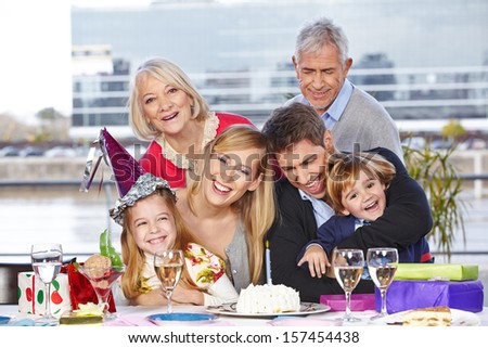 Happy family having fun at birthday party of their daughter