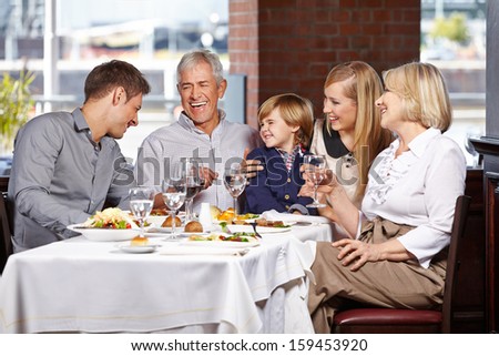 Happy family with child smiling together in a restaurant