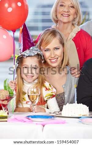 Happy mother and grandmother celebrating their daughter\'s birthday