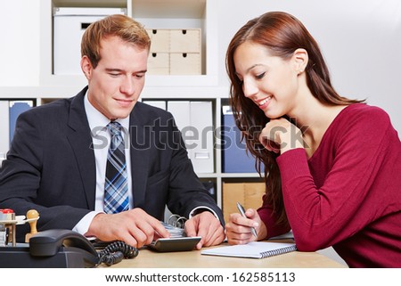 Financial consultant speaking with a female client in the office about insurances