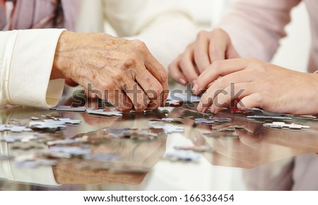 Old Hands Solving Jigsaw Puzzle In A Nursing Home