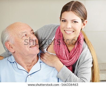 Smiling Extended Care Assistant With Happy Senior Citizen