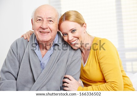 Happy family with woman embracing senior citizen man
