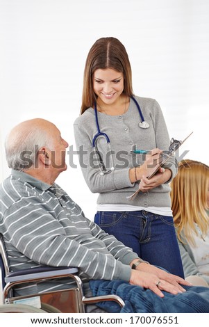 Woman doing survey with senior man for quality management in nursing home