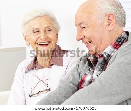 Happy smiling senior couple in a retirement home