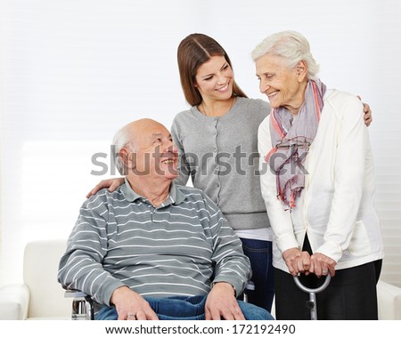 Happy family with smiling senior couple at home