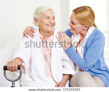 Happy Senior Citizen Woman At Home Looking At Her Daughter