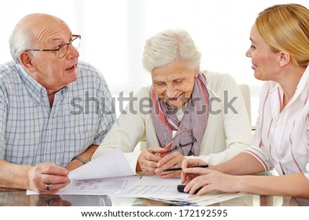Couple Of Senior Citizens Talking To Financial Consultant About Their Pension