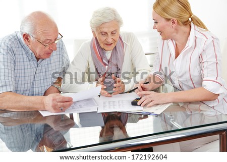 Senior couple getting financial consultation from insurance woman