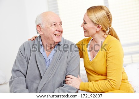 Woman And Old Senior Man In Retirement Home Smiling At Each Other