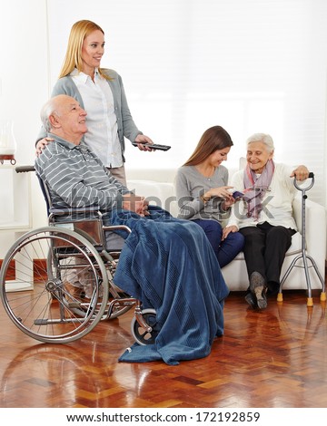 Caregiver entertaining senior citizens in a retirement home