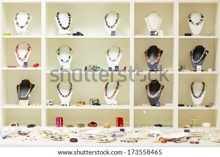 Shop window with necklaces and jewelry on display at jeweler