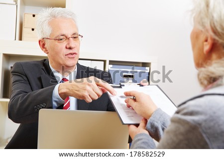 Senior woman getting minutes of consultation from her financial consultant