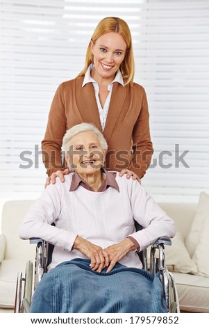 Happy family with woman and senior citizen in a wheelchair