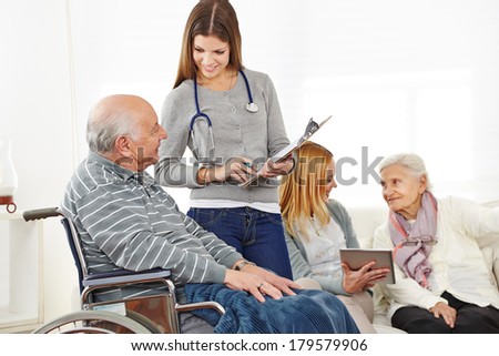 Caregiver doing survey with senior citizens in a nursing home
