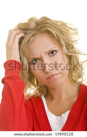 stock photo Young blonde woman scratching her head