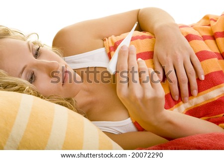 Blonde woman in bed with clinical thermometer