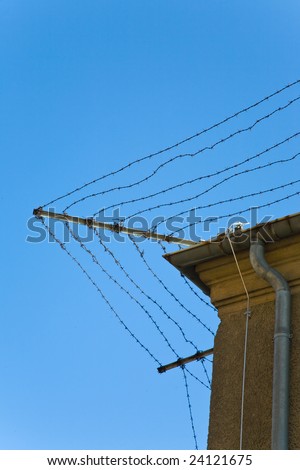 Barbed wire fence on a prison wall