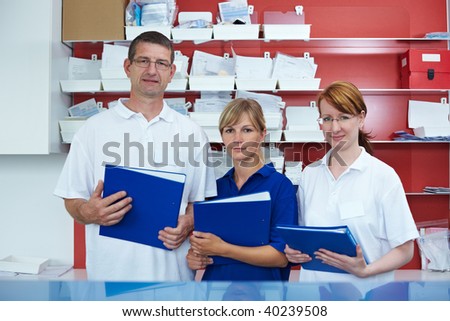 Three dental technicians in a dental lab