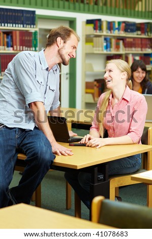 Student talking with a female student in library