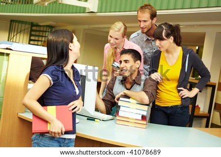 Library staff helping a student at counter